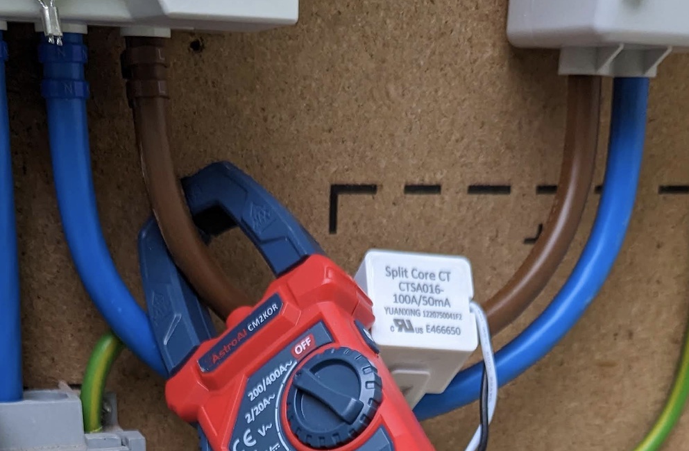 Photograph of somewhat obscured CT clamp connected to meter tails.