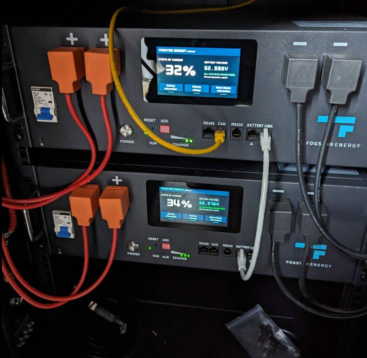 Close-up of two Fogstar battery BMS screens showing SOC drift: top battery at 32%, bottom at 34%