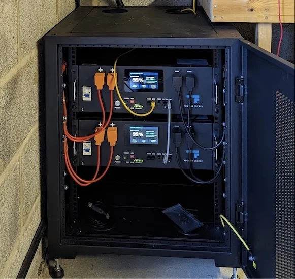 Photograph of batteries in parallel. The batteries are inside a rack.