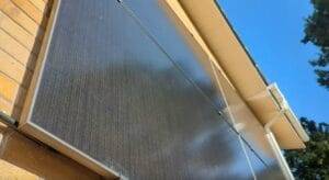 An image of a wall with solar panels from the ground up. On a nice sunny day.