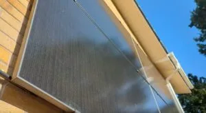 An image of a wall with solar panels from the ground up. On a nice sunny day.