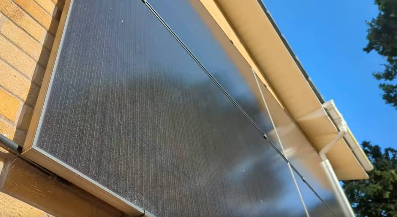 An image of a wall with solar panels from the ground up. On a nice sunny day.